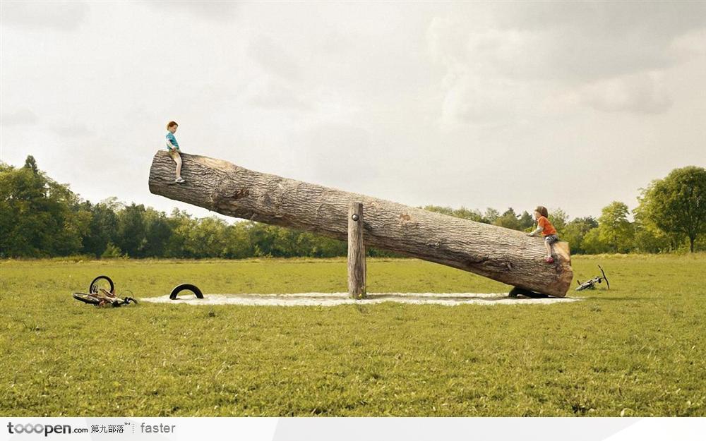 两小孩在玩大树翘翘板