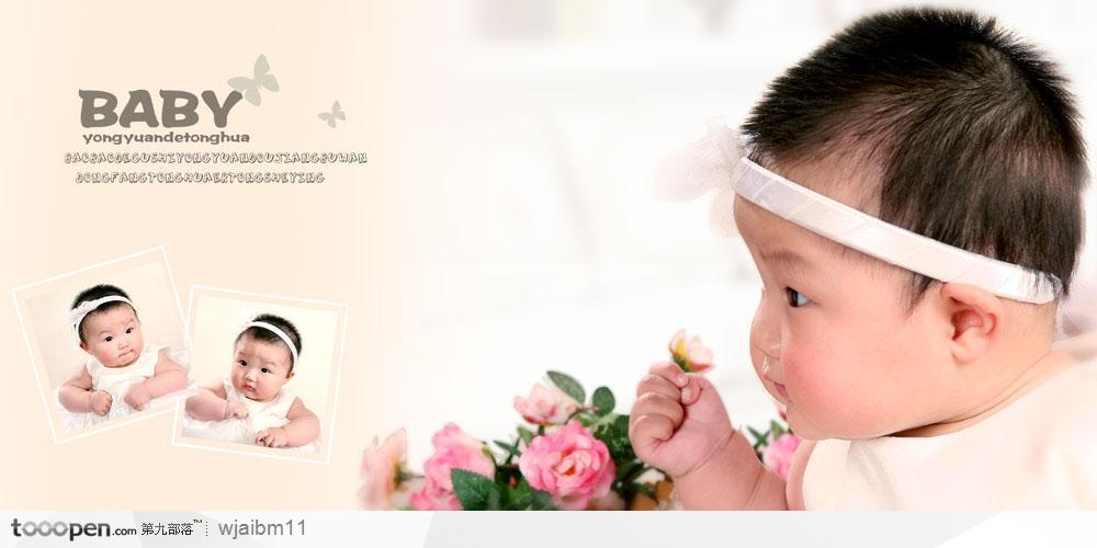 穿着婴儿装的婴儿头戴白色头巾手拿一小朵花的艺术照