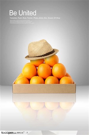 整齐堆叠摆放在牛皮纸盒子上的橙子和放在最上面的帽子