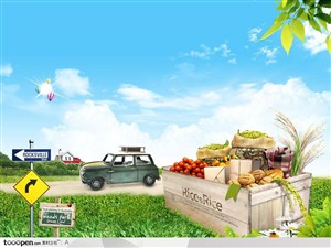 绿色草地上装满水果的木箱子和行驶在公路上的汽车