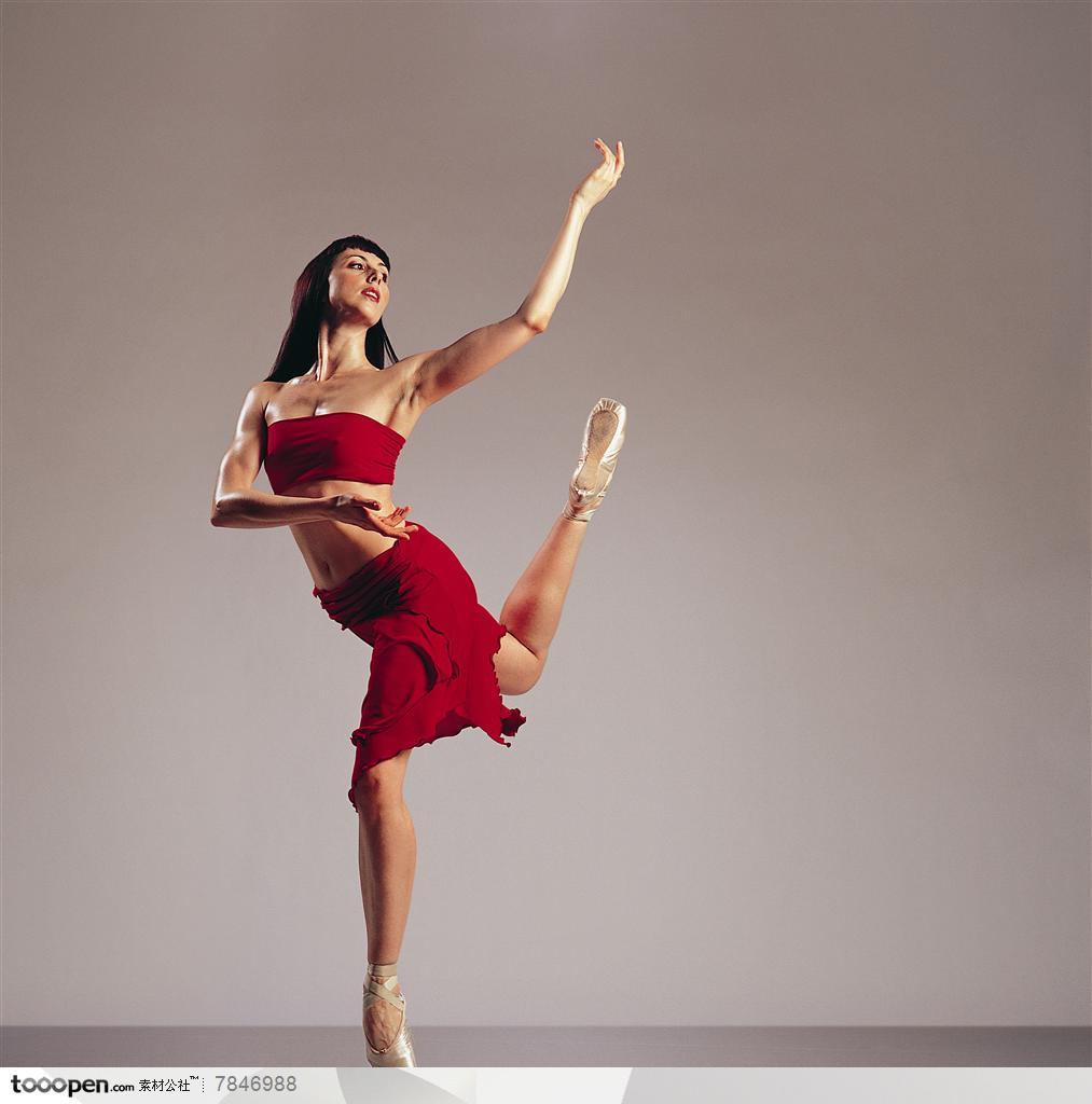 舞蹈动作-穿红色裙子的外国美女踮起脚尖托起双手的舞蹈动作