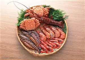 放在簸箕里的两只大螃蟹、基围虾、大龙虾等海鲜
