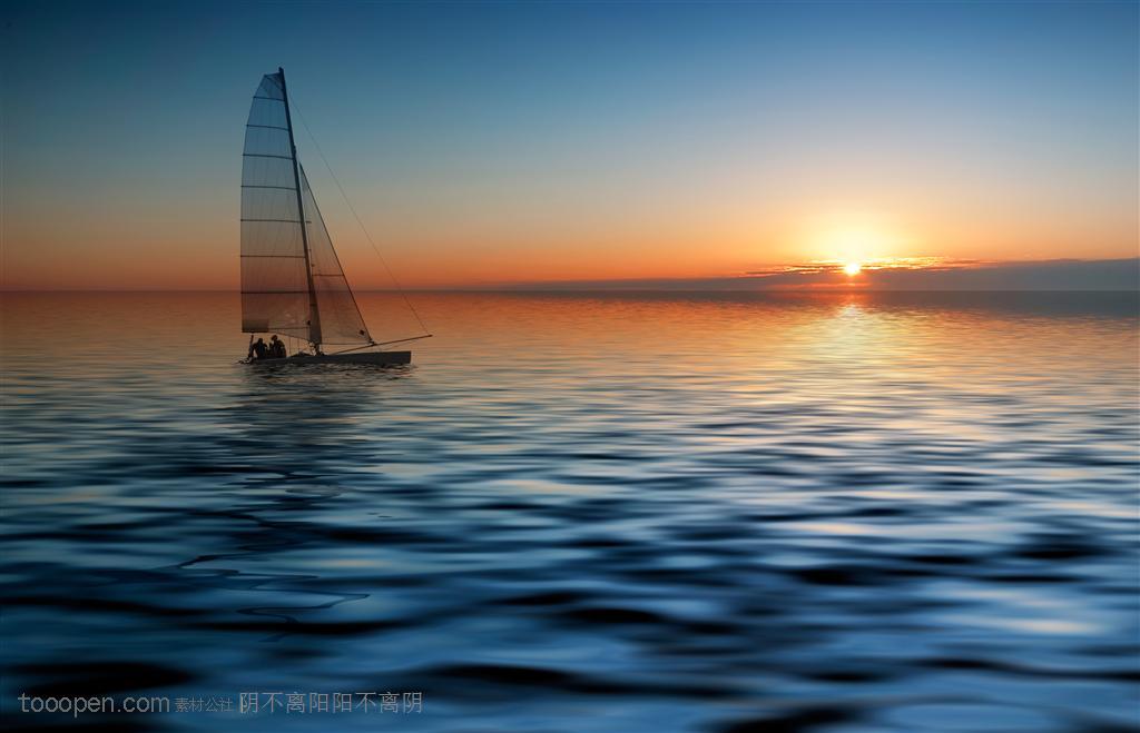 夕阳下静静的海面上的小型帆船