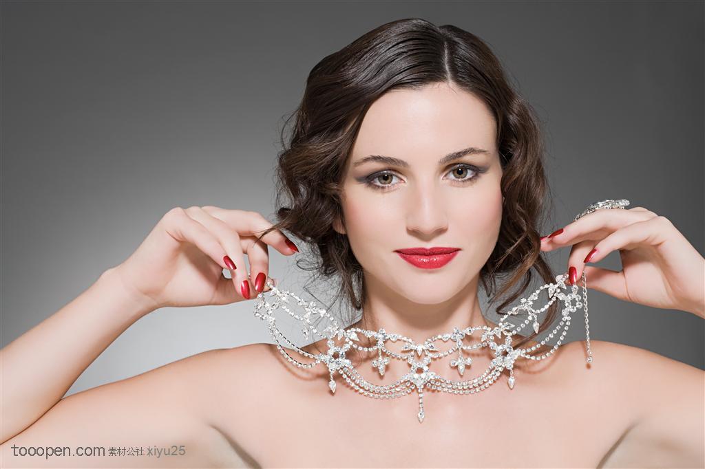 美容保健-提着钻石项链的美女珠宝图片